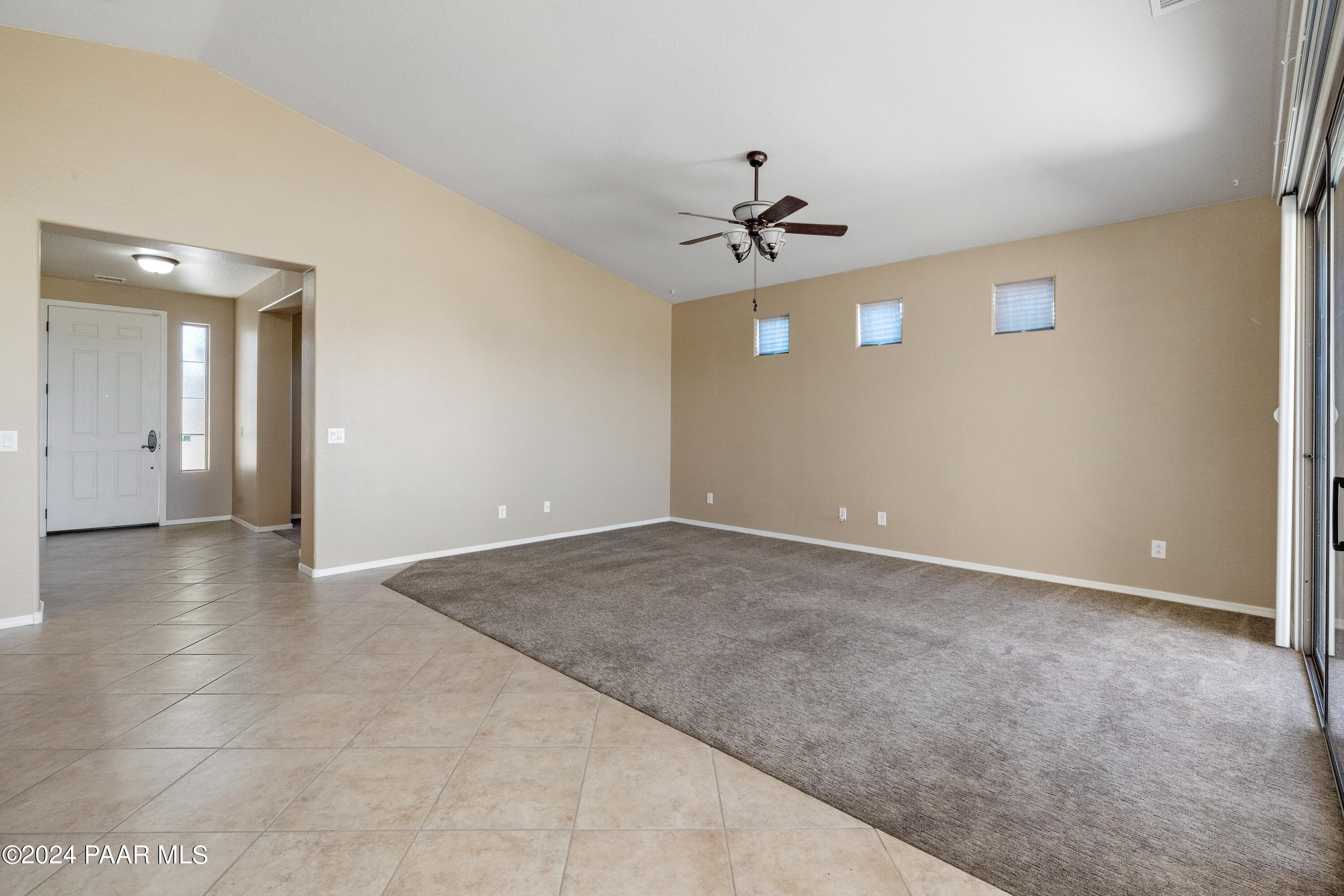 1195 Rigo Ranch Road Prescott Valley, AZ 86314 - Photo 5 of 65 a view of a big room with windows and chandelier fan