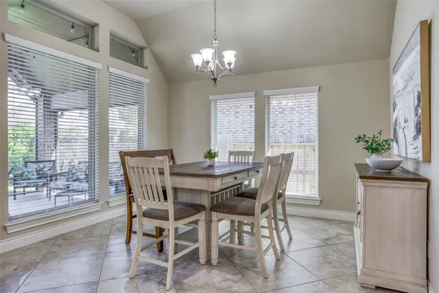 a view of a dining room with furniture and window