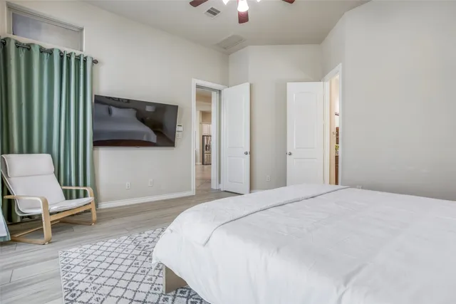 a bedroom with a bed and a chair