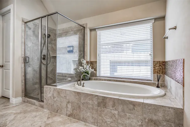a bathroom with a tub and a sink