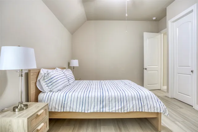 a bedroom with a bed and a lamp