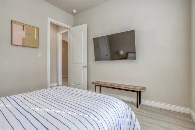 a bedroom with a bed and a flat screen tv