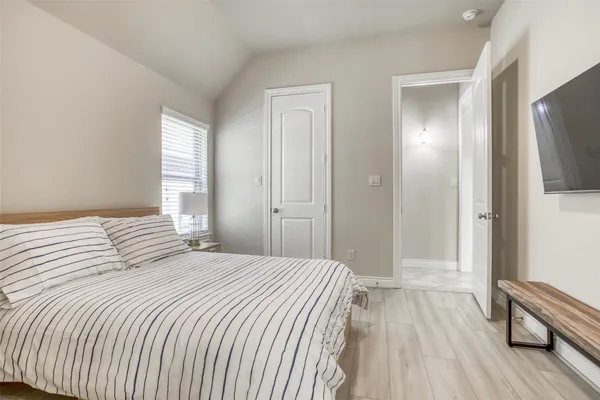 a bedroom with a bed and a mirror