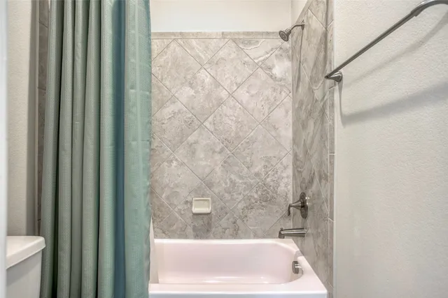 a bath tub sitting next to a white sink