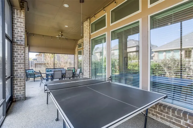 a view of backyard with potted plants and wooden fence
