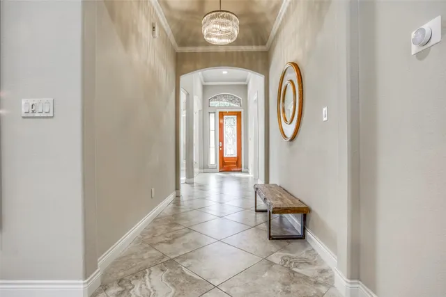 a living room with a bed and a chandelier