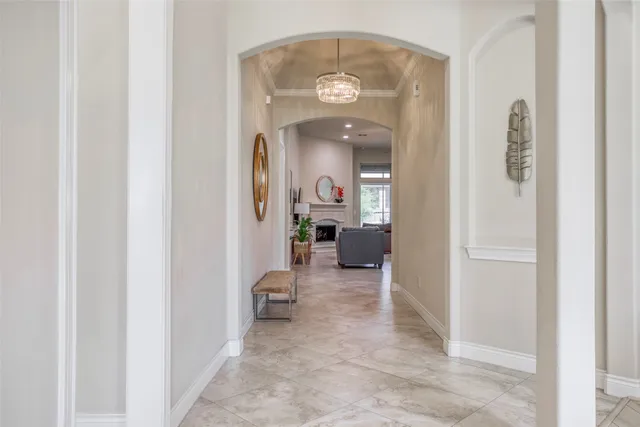 a view of a hallway with livingroom and furniture