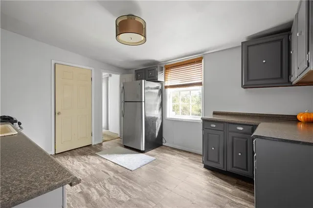 a kitchen with a refrigerator and a sink