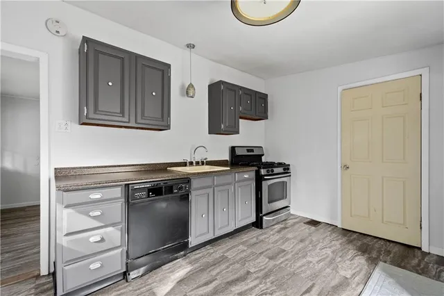 a kitchen with stainless steel appliances granite countertop a stove and a microwave