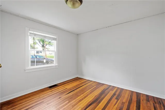 a view of a room with wooden floor and bathroom