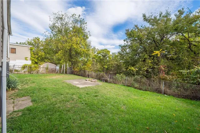 a view of a house with a yard and sitting area