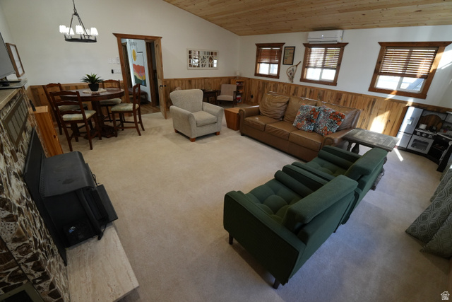3711 North Canyon Road Provo, UT 84604 - Photo 26 of 42 Carpeted living room featuring wooden walls, wainscoting, vaulted ceiling, wooden ceiling, and a chandelier