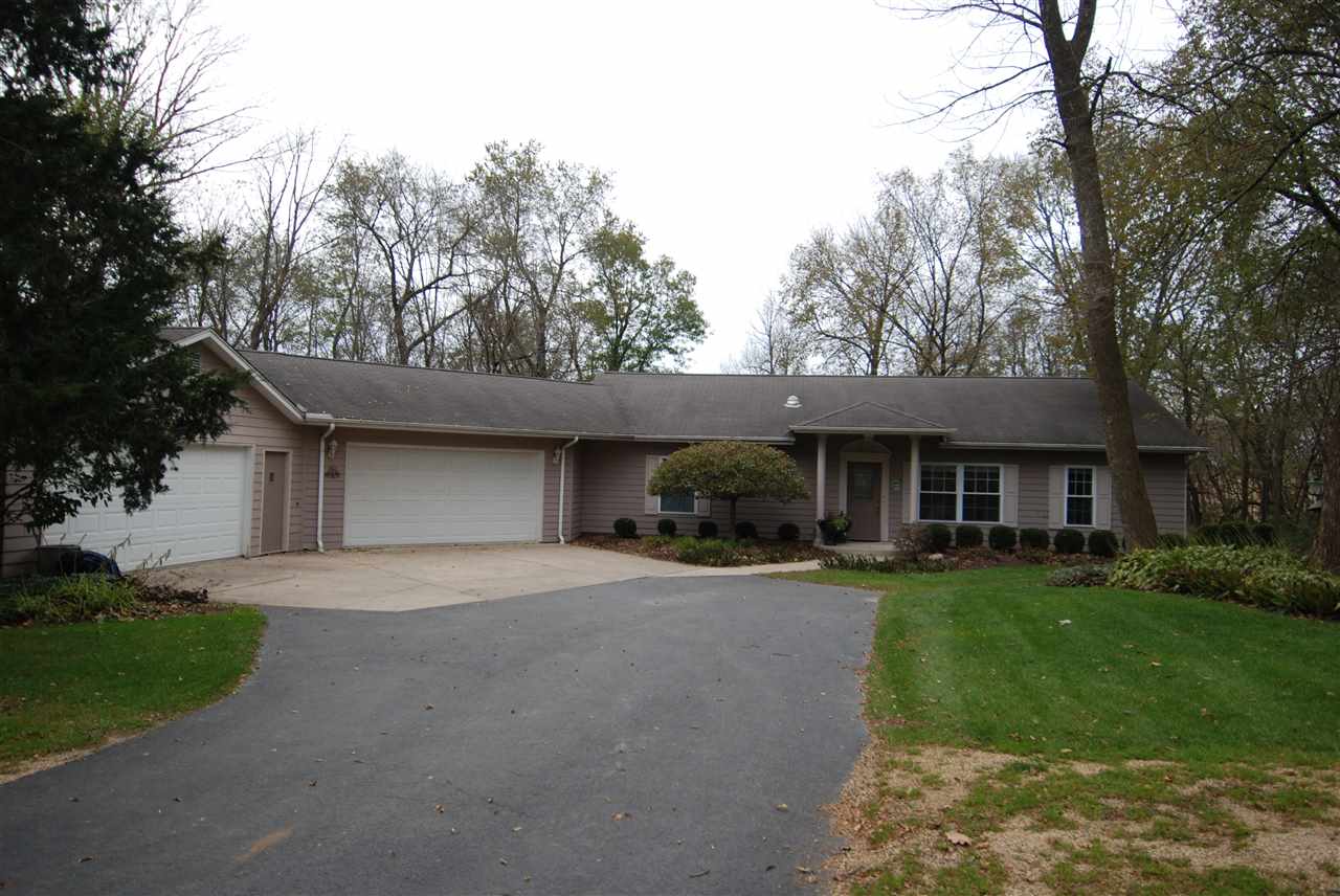10018 East Campbell Road Davis, IL 61019 - Photo 1 of 15 a front view of a house with a garden and trees
