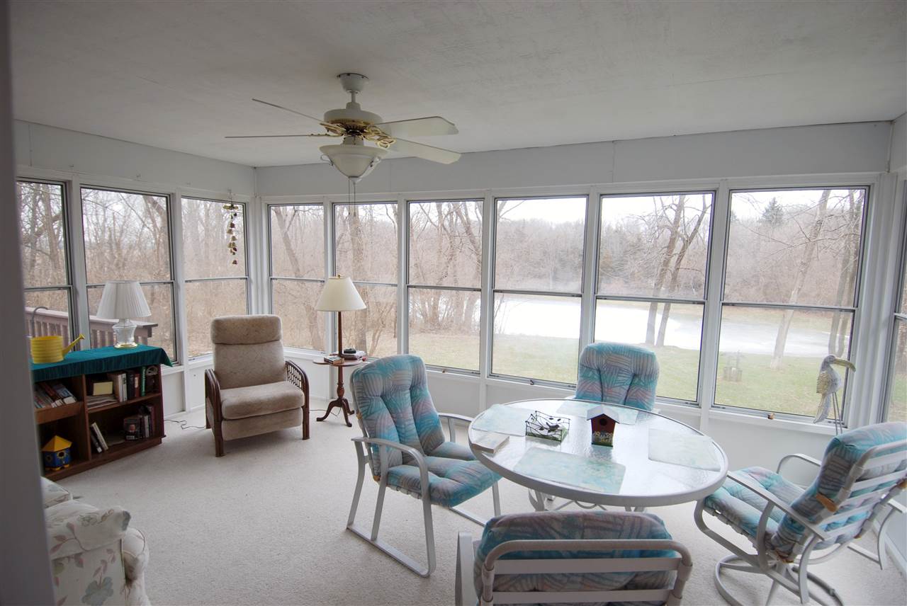 10018 East Campbell Road Davis, IL 61019 - Photo 6 of 15 a view of a dining room with furniture a chandelier and wooden floor
