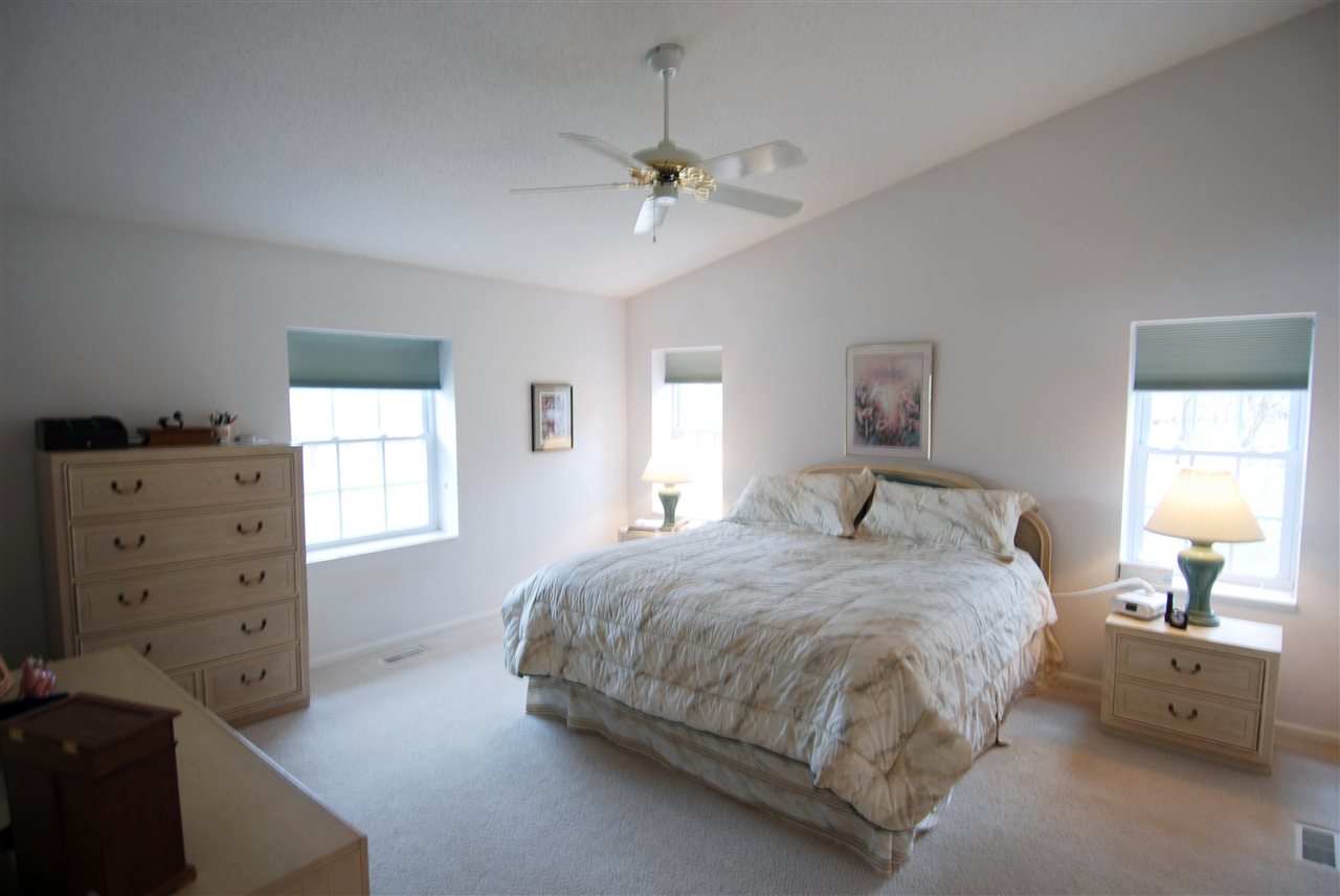 10018 East Campbell Road Davis, IL 61019 - Photo 7 of 15 a spacious bedroom with a bed and a dresser