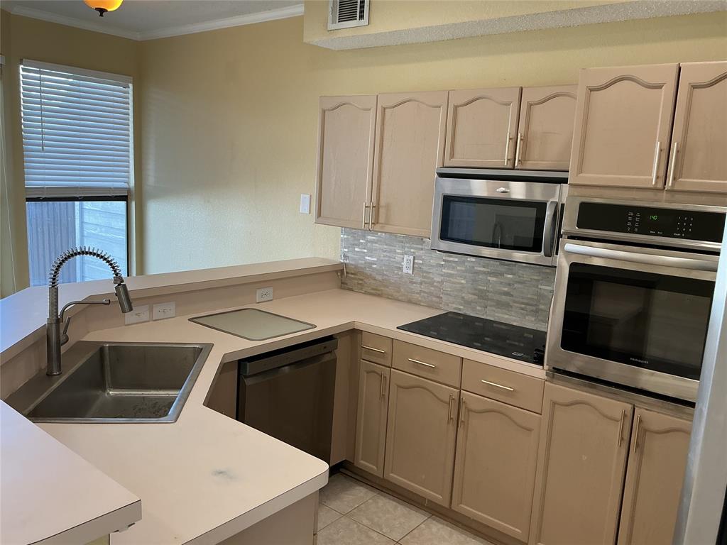 6027 Homestead Court Dallas, TX 75252 - Photo 4 of 23 kitchen with breakfast bar and new appliance