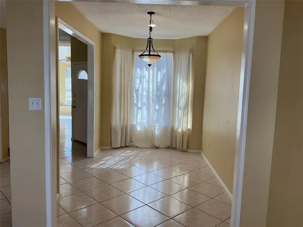 an empty room with wooden floor and door