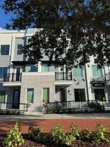 a front view of an apartment building with a yard