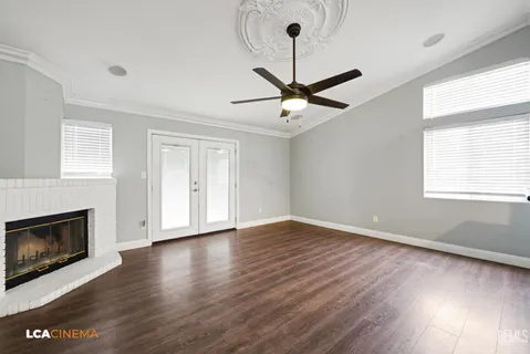 a kitchen with granite countertop a refrigerator and a stove top oven