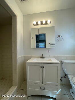 4315 41st Street Lubbock, TX 79413 - Photo 12 of 14 a bathroom with a sink and a mirror
