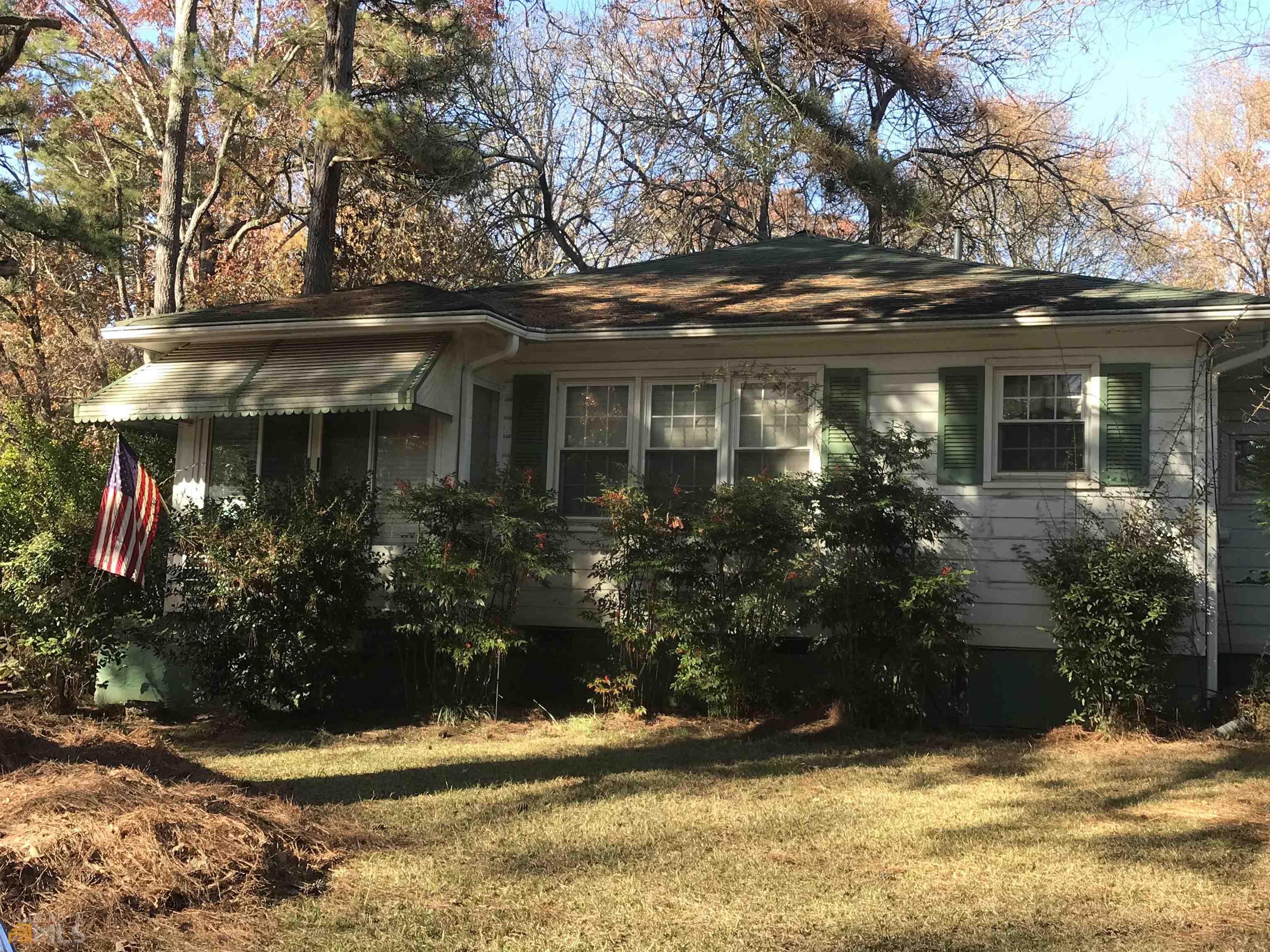 a view of a house with brick walls and flower plants