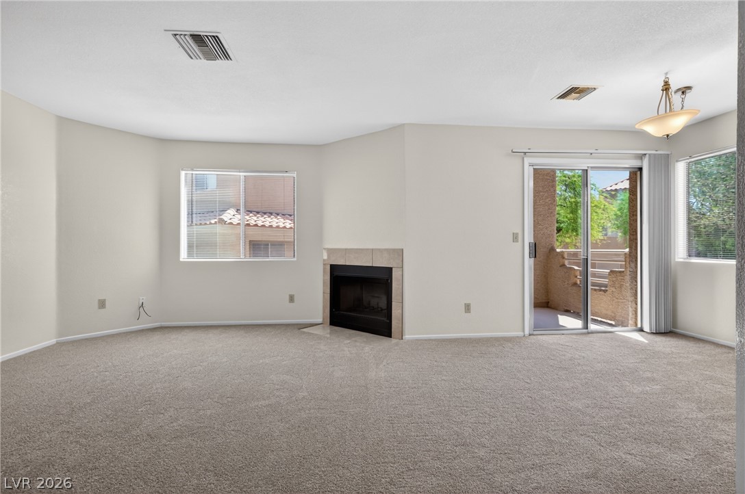 2241 Highpointe Drive, Unit 101 Laughlin, NV 89029 - Photo 6 of 23 This inviting living space features soft carpeting, a cozy fireplace, and access to a private patio.