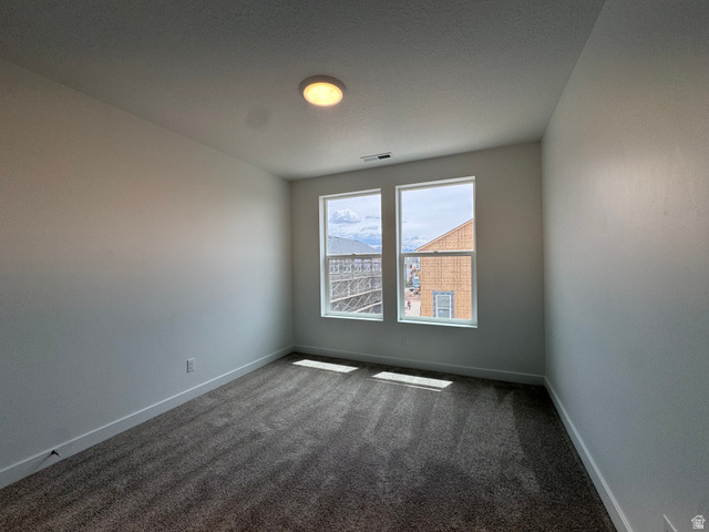 1883 West 1575th North, Unit 236 Layton, UT 84041 - Photo 12 of 22 Spare room featuring dark colored carpet and baseboards