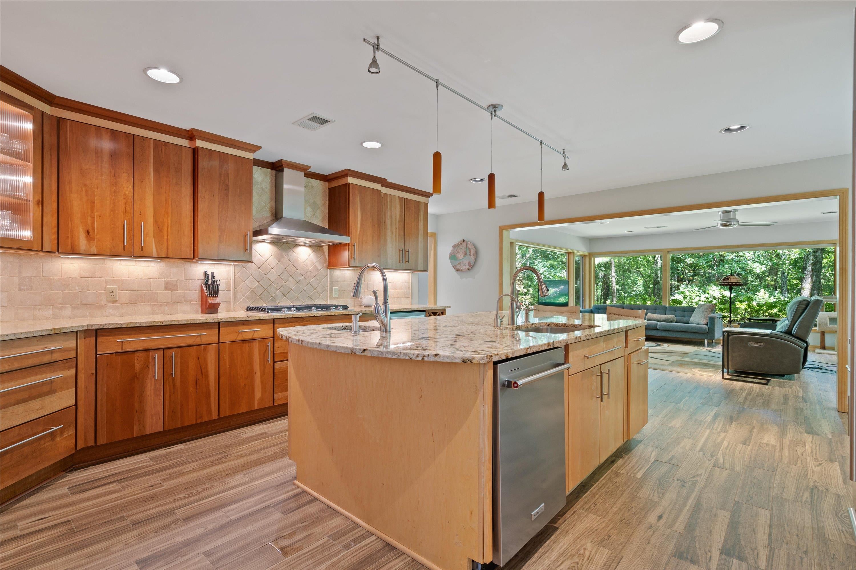 964 Rocky Point Road Memphis, TN 38018 - Photo 8 of 25 a kitchen with kitchen island granite countertop a stove a sink and wooden cabinets