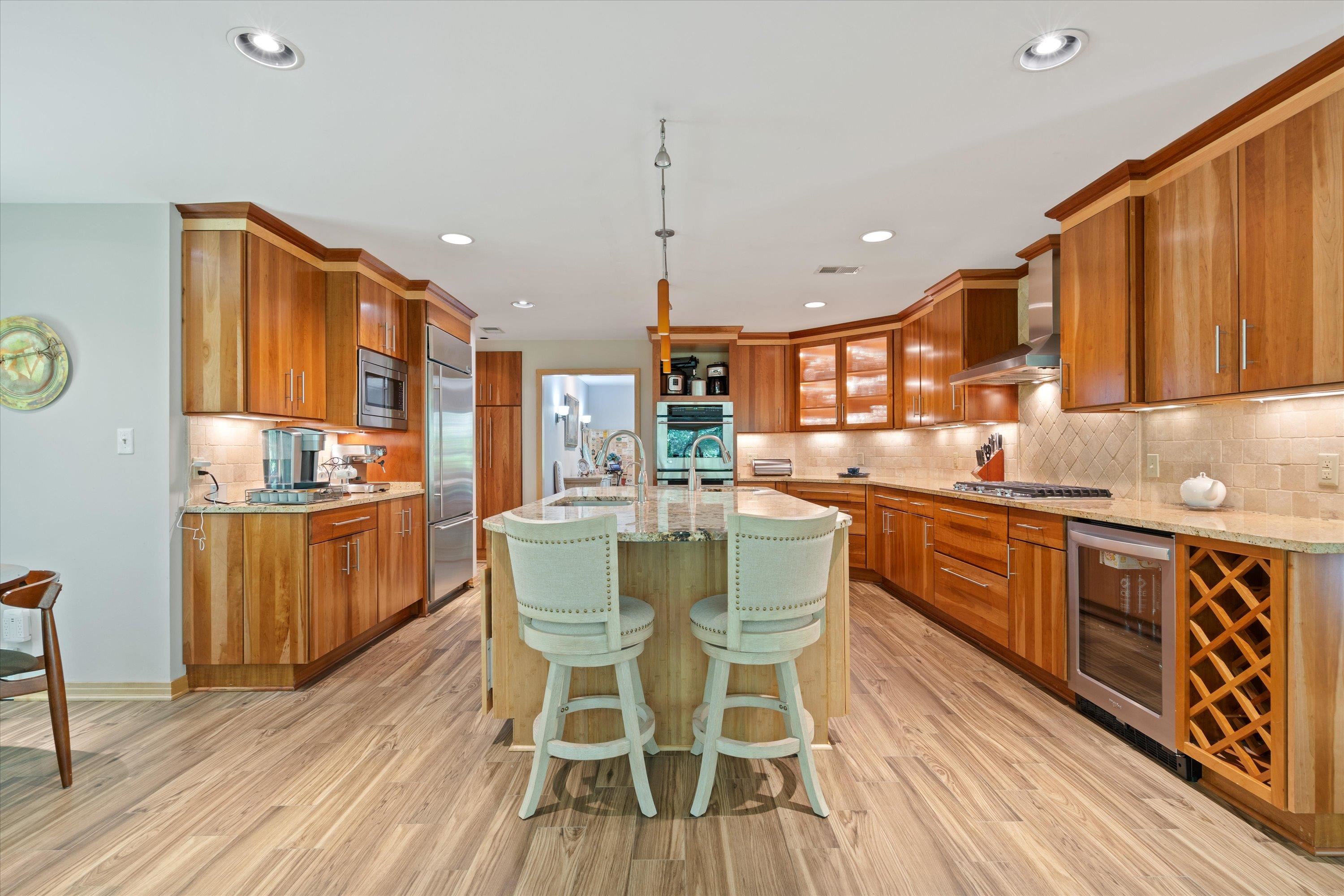 964 Rocky Point Road Memphis, TN 38018 - Photo 9 of 25 a kitchen with stainless steel appliances granite countertop a kitchen island hardwood floor sink and wooden cabinets