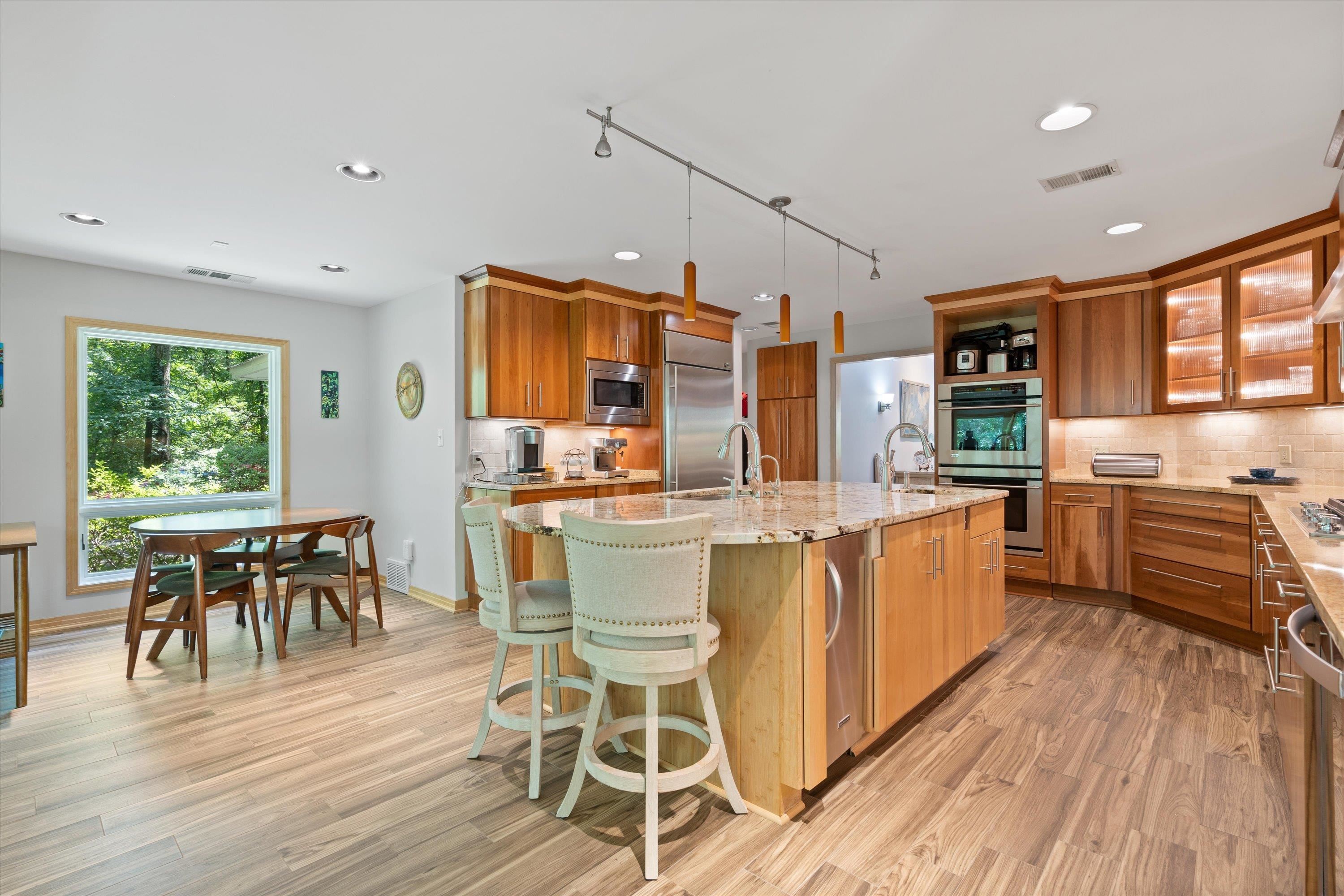 964 Rocky Point Road Memphis, TN 38018 - Photo 10 of 25 a dining room with stainless steel appliances granite countertop furniture wooden floor and view kitchen