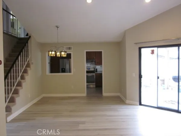 a kitchen with granite countertop a stove sink and refrigerator