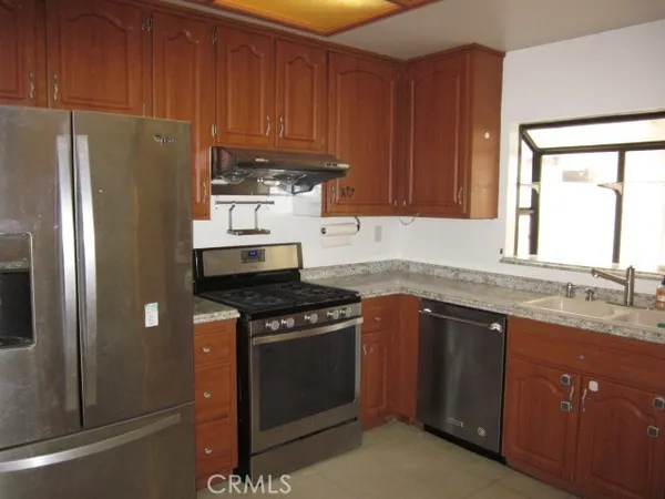 a kitchen with metallic refrigerator freezer and a dishwasher