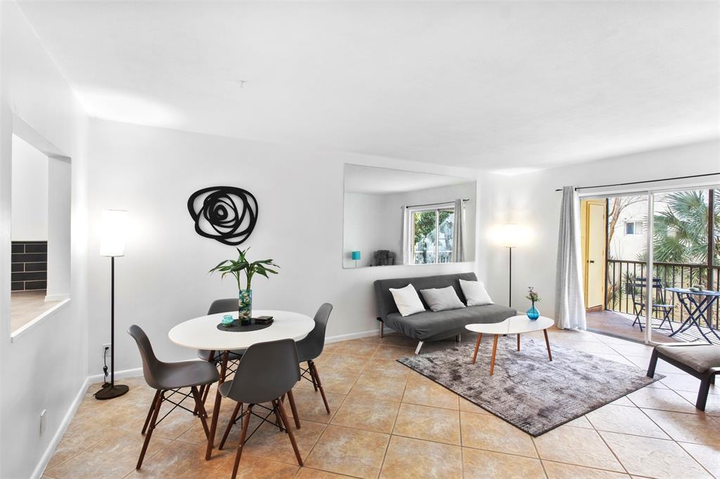 251 South Cypress Road, Unit 127 Pompano Beach, FL 33060 - Photo 2 of 29 a living room with furniture and a table