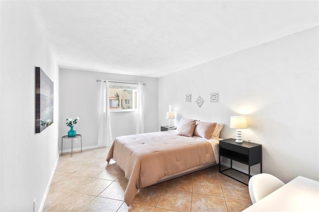 251 South Cypress Road, Unit 127 Pompano Beach, FL 33060 - Photo 5 of 29 a bedroom with bed and window