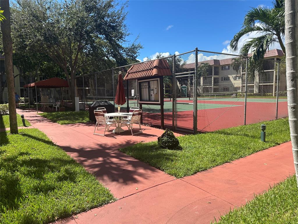251 South Cypress Road, Unit 127 Pompano Beach, FL 33060 - Photo 10 of 28 Barbeque and Tennis Court Area