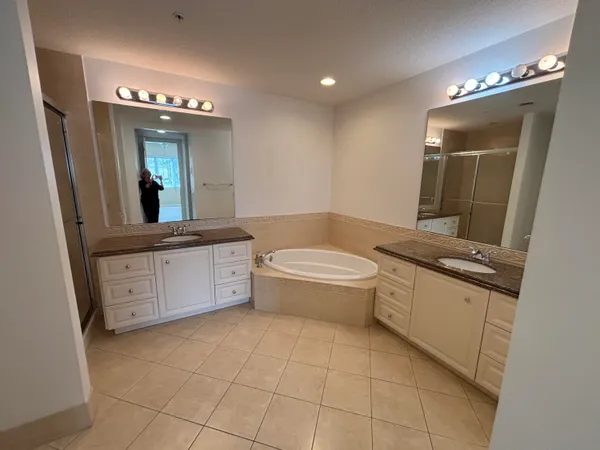 a bathroom with a granite countertop sink a toilet and mirror