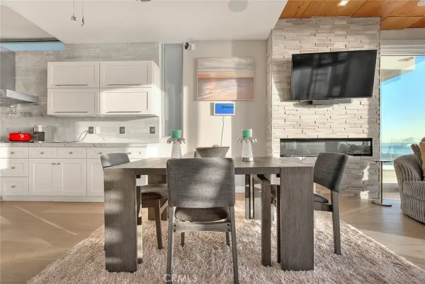 a living room with stainless steel appliances granite countertop furniture and a kitchen view