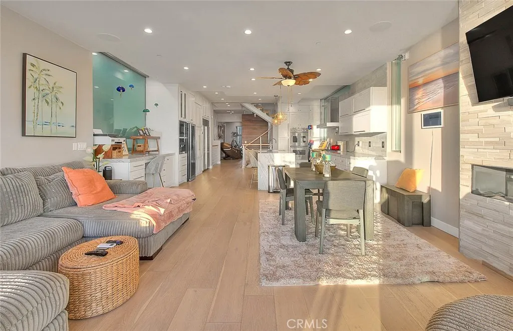 99 Surfside Avenue Surfside, CA 90743 - Photo 26 of 75 a living room with furniture and a dining table with kitchen view