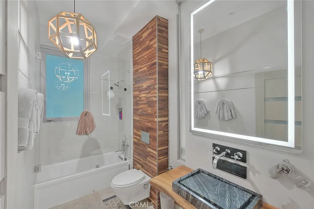 99 Surfside Avenue Surfside, CA 90743 - Photo 29 of 75 a bathroom with a sink a toilet and shower