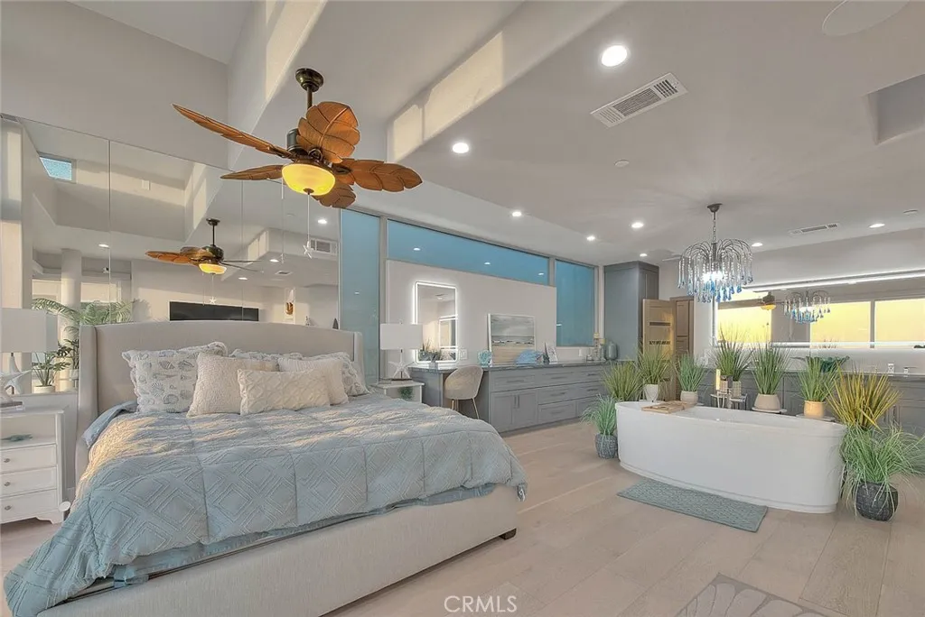 99 Surfside Avenue Surfside, CA 90743 - Photo 33 of 75 a bedroom with a large bed and a chandelier