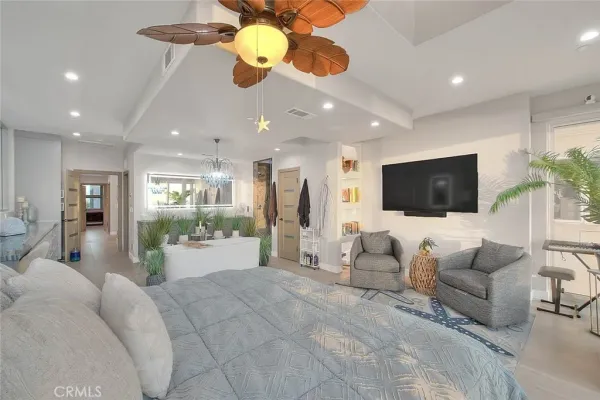 a bedroom with furniture and a flat screen tv