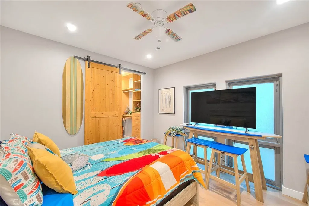 99 Surfside Avenue Surfside, CA 90743 - Photo 42 of 75 a bedroom with a bed and a flat screen tv