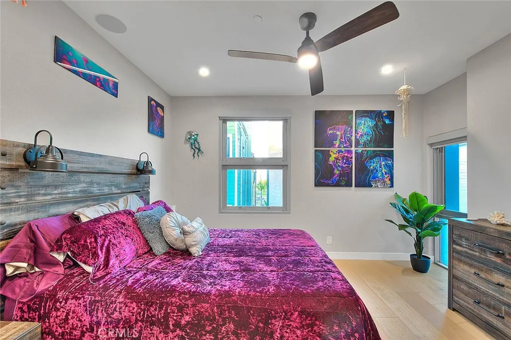 99 Surfside Avenue Surfside, CA 90743 - Photo 46 of 75 a bedroom with a large bed and a potted plant