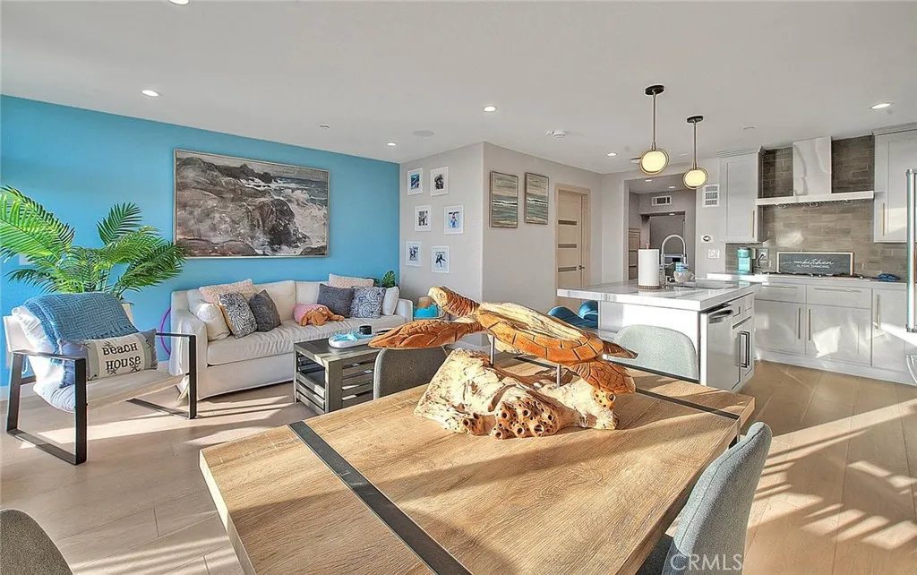 99 Surfside Avenue Surfside, CA 90743 - Photo 7 of 75 a living room with furniture and a chandelier