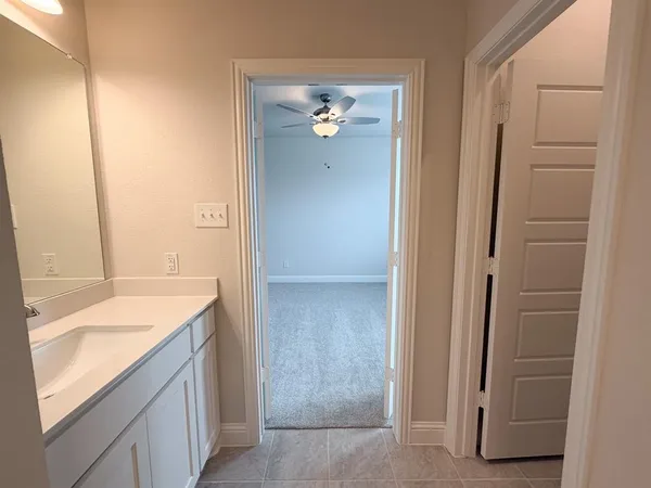 a bathroom with a sink a toilet a mirror and bathtub