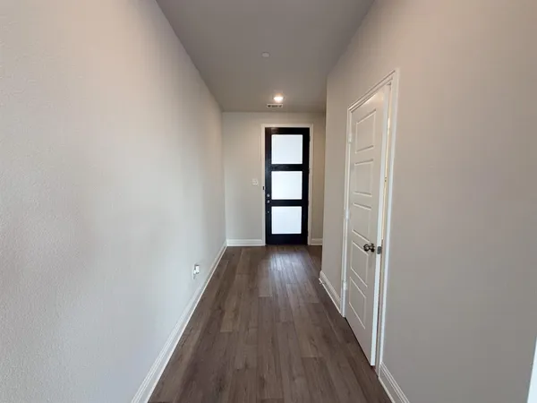 a view of hallway with wooden floor