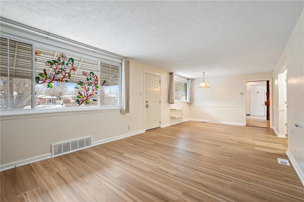 138 Rama Road Beaver Falls, PA 15010 - Photo 11 of 25 a view of empty room with wooden floor and fan