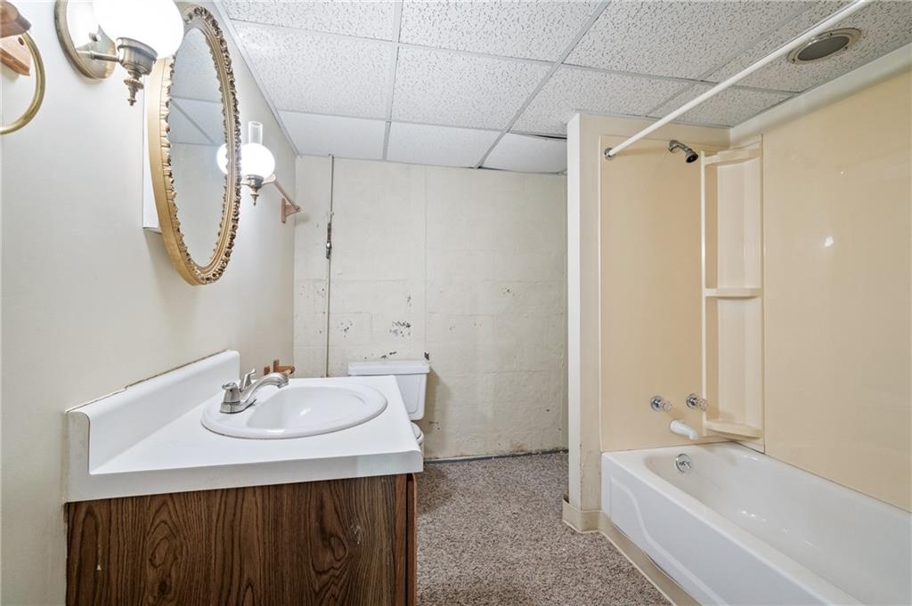 138 Rama Road Beaver Falls, PA 15010 - Photo 18 of 25 a bathroom with a bathtub a sink and a mirror