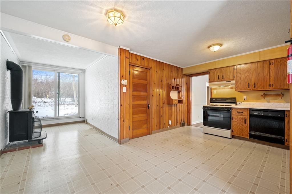 138 Rama Road Beaver Falls, PA 15010 - Photo 4 of 25 a kitchen with granite countertop a refrigerator and a stove top oven