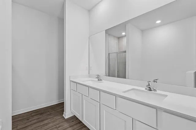 a bathroom with a double vanity sink and a mirror